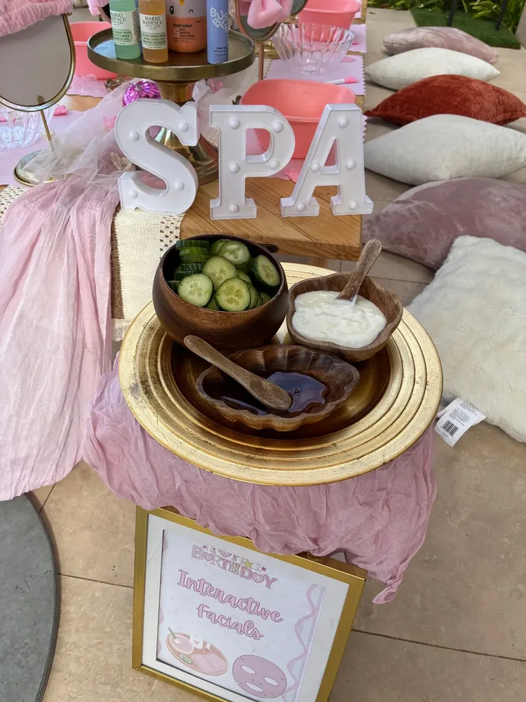 Facial cream, cucumbers, spa accessories, and lettered SPA decor.