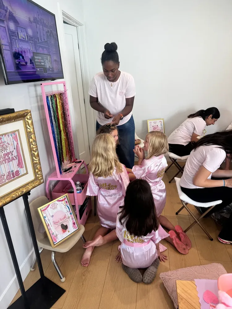 Children in satin robes during a group spa party activity.